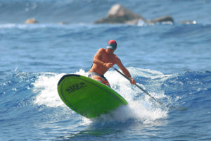 Riding waves with a paddle board at Kahaluu Bay