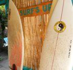 Surfboards leaning against wall.