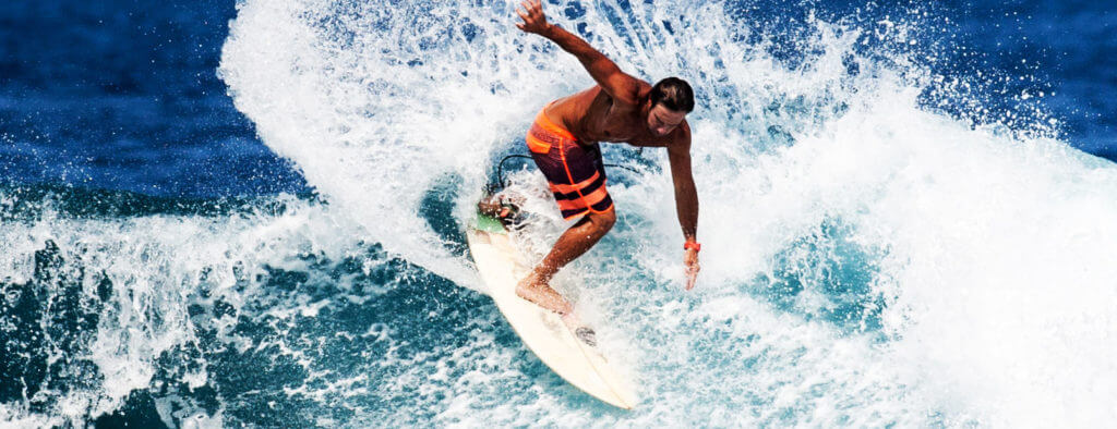 surfer riding a wave at Kahaluu bay in kona hawaii