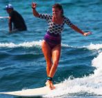 Woman surfer cross steping on a longboard in Hawaii